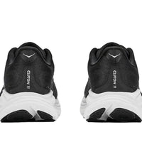 Black running shoes with white soles on a white background