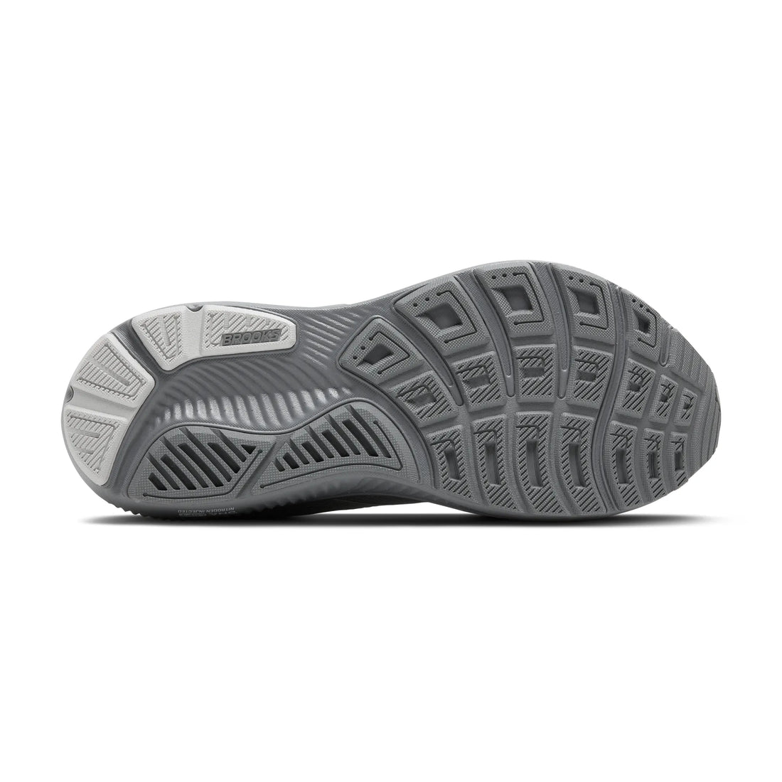 Gray athletic shoe with textured sole on a white background