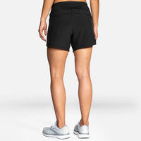 Person wearing black athletic shorts on a white background