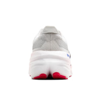 Back view of a gray and white sneaker with red accents on a white background