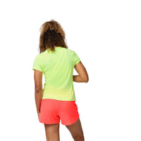 Person wearing a bright green shirt and pink shorts on a plain background