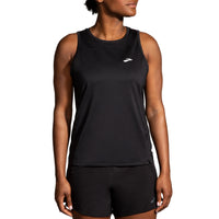 Person wearing a black sleeveless top with a brand logo on a white background
