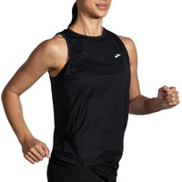 Person wearing a black sleeveless athletic shirt with a brand logo on a white background