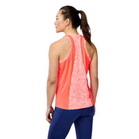 Woman wearing a pink and blue athletic outfit on a gray background
