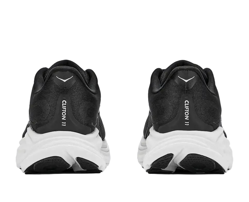 Black running shoes with white soles on a white background