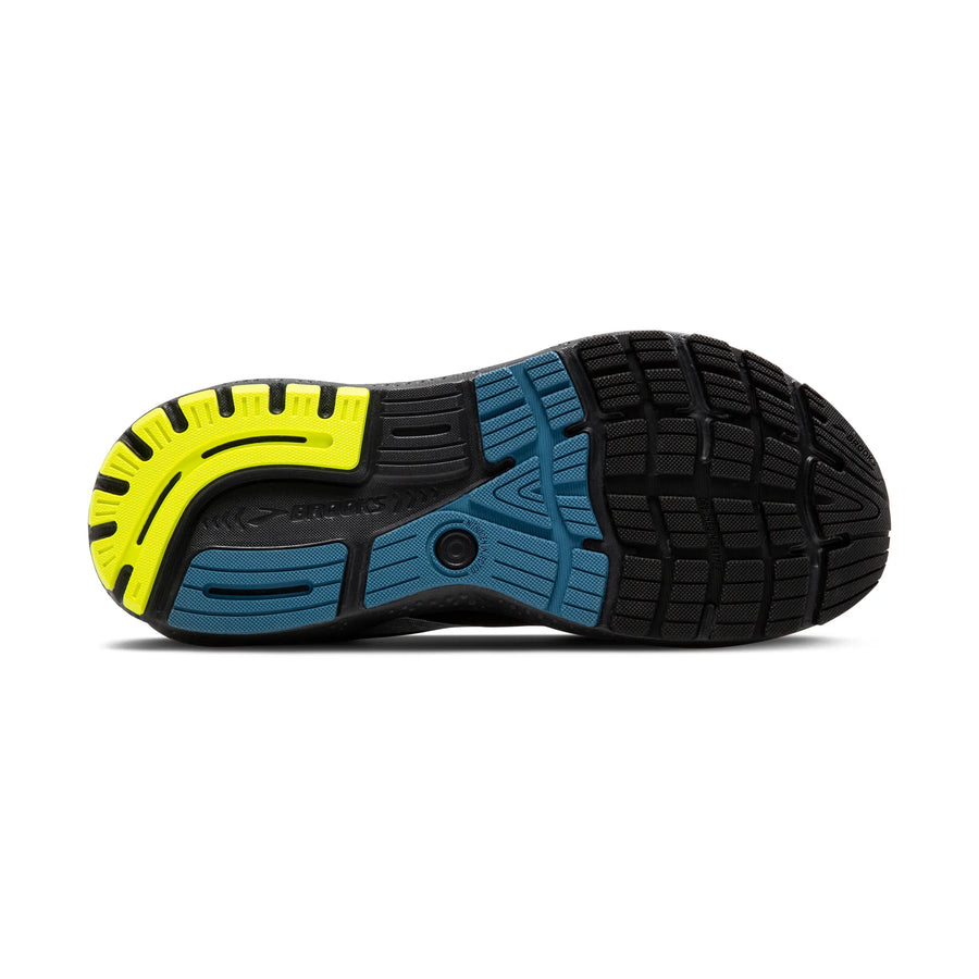 Close-up of a shoe sole with black, blue, and yellow design on a white background