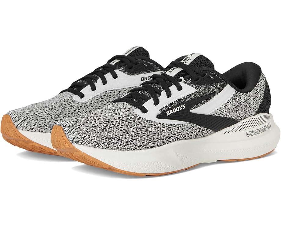 Gray and black running shoes with white soles on a white background