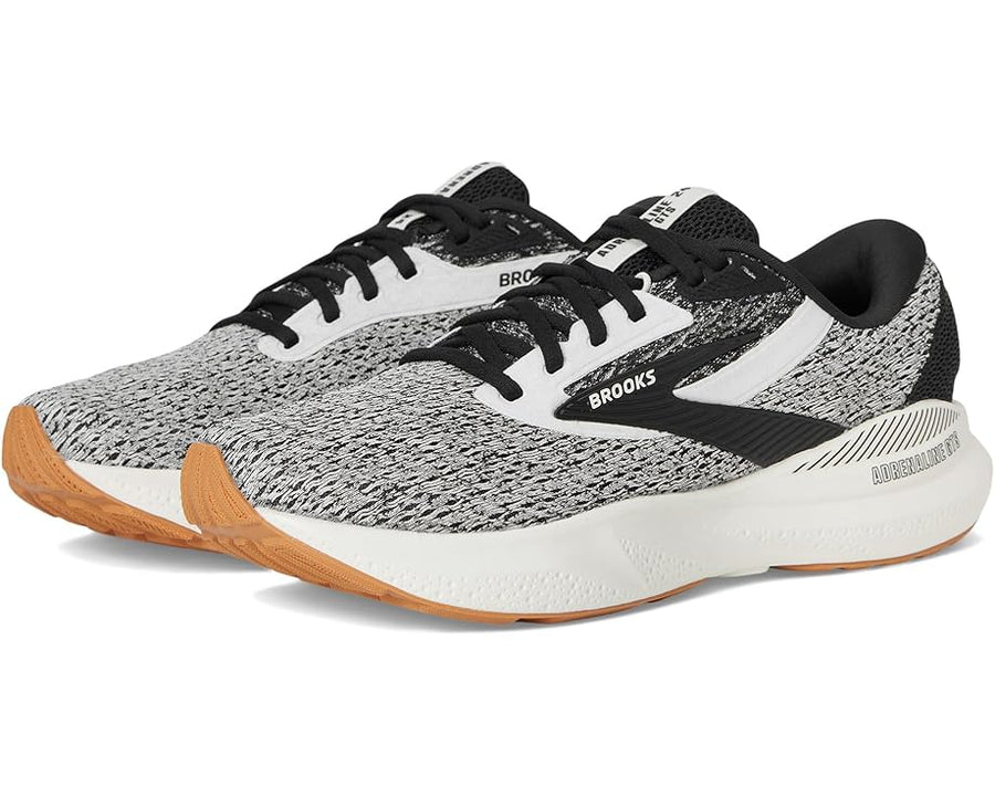 Gray and black running shoes with white soles on a white background