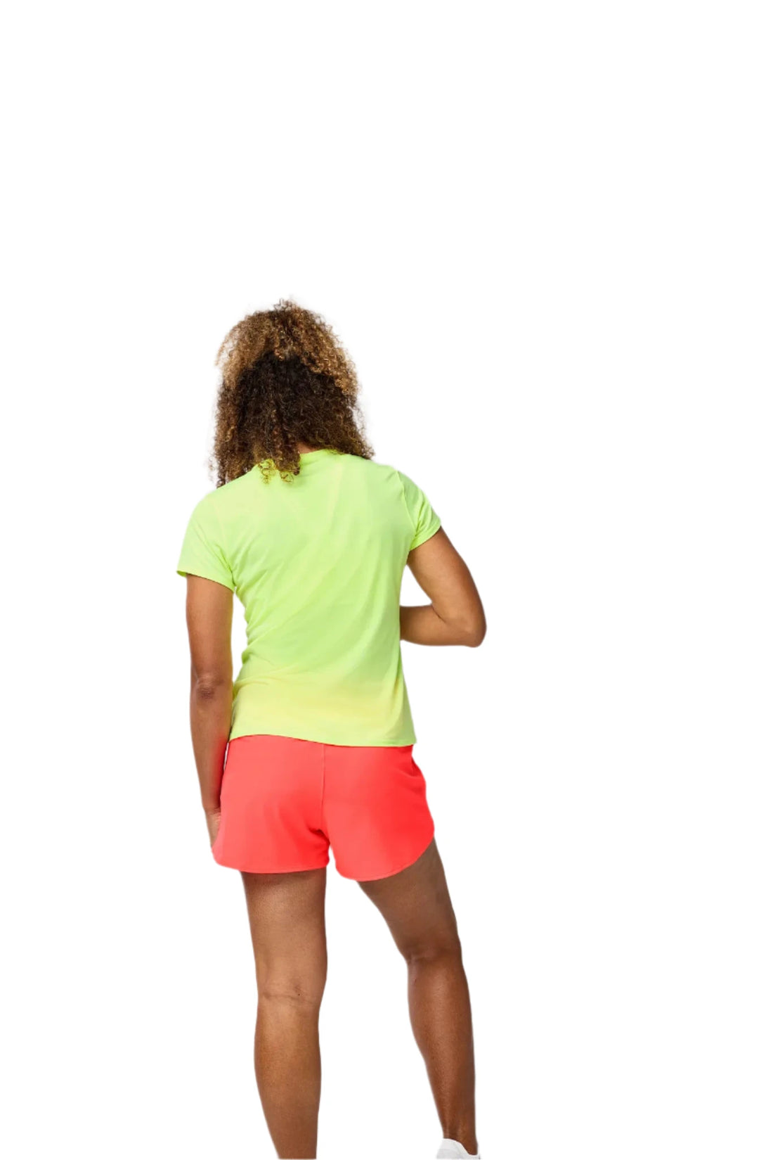 Person wearing a bright green shirt and pink shorts on a plain background
