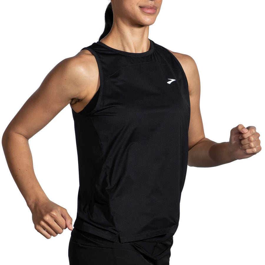 Person wearing a black sleeveless athletic shirt with a brand logo on a white background