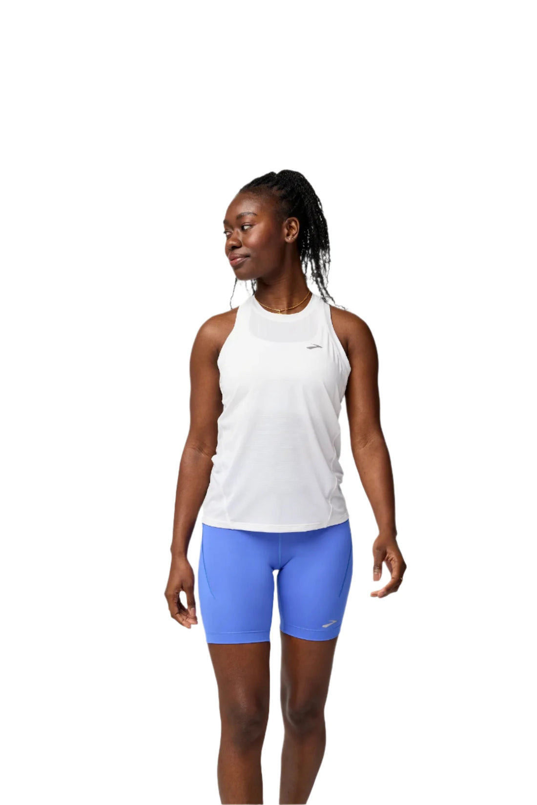 Person wearing a white tank top and blue shorts on a light gray background